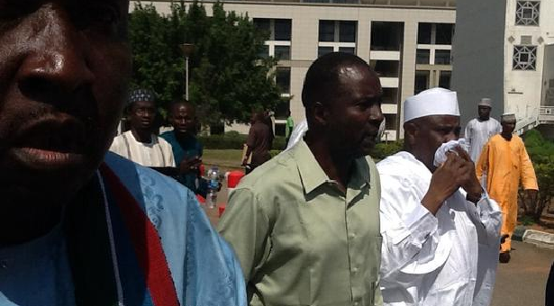 tamb nose - THEWILL NEWS MEDIA House Speaker Aminu Tambuwal (In White) Covering His Nose After Police Tear-Gassed Lawmakers.
