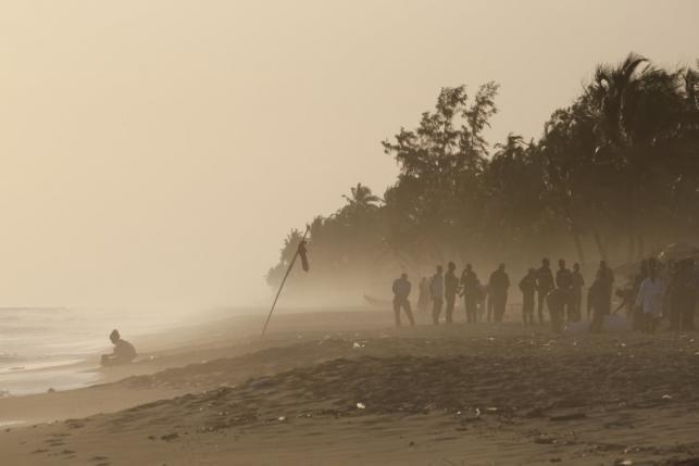 Emergency workers and security officers gather on a beach after an attack in Grand Bassam, Ivory Coast, March 13, 2016. REUTERS/Joe Penney