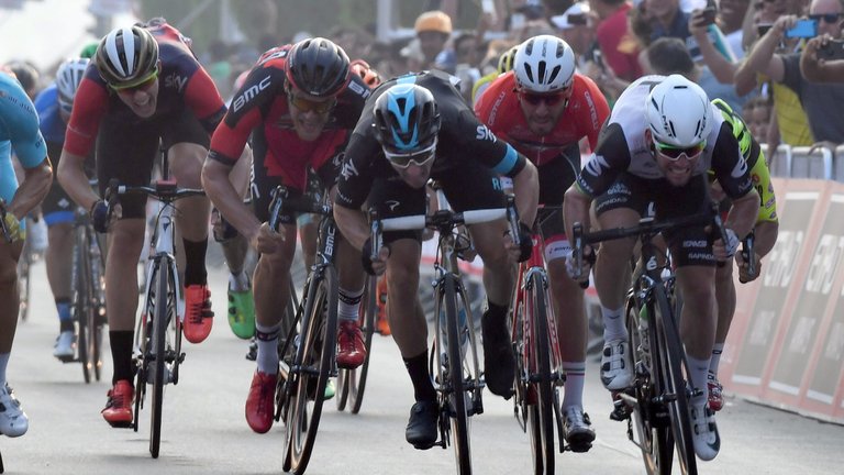 Cavendish (right) comes past Elia Viviani (centre) in the finishing straight