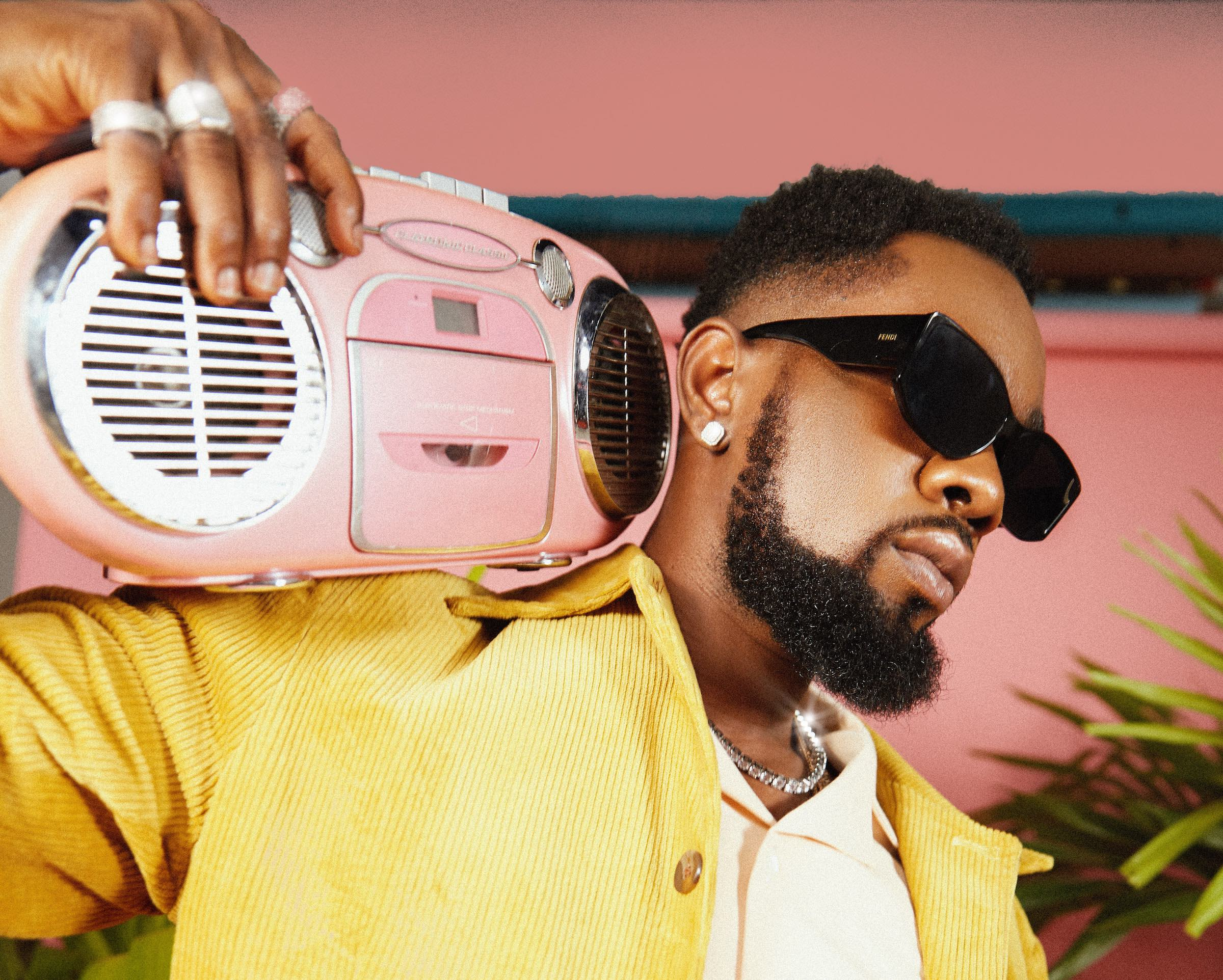 Patoranking with radio on his shoulder
