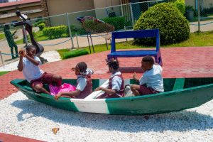 Students playing inside a canoe. - THEWILL NEWS MEDIA Students playing inside a canoe.