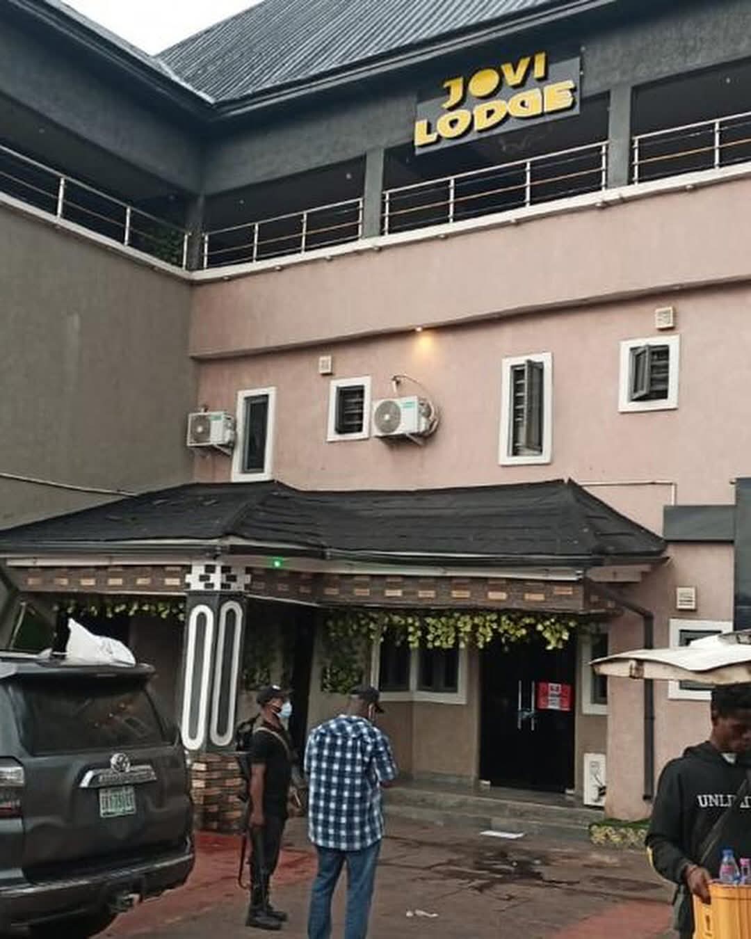 Exterior view of a building with a prominent yellow 'JOVI LODGE' sign above the entrance