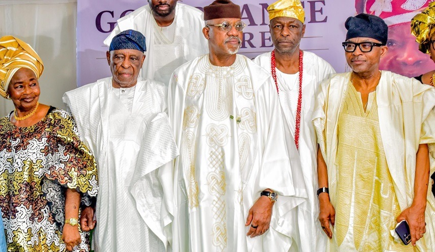 ogun state Traditional Rulers - THEWILL NEWS MEDIA Five people in white and gold Nigerian agbada outfits posing at a cultural event; woman on left in a patterned dress and headwrap.