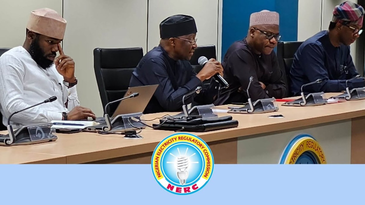 A representation of meeting between NERC and DisCos - THEWILL NEWS MEDIA A panel of four men in traditional attire seated at a conference table with microphones and laptops, NERC logo in front.