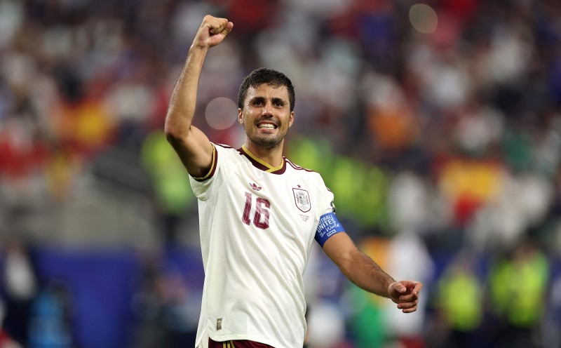 France v Spain: Semi Final - FIFA World Cup 2026 - THEWILL NEWS MEDIA Soccer player in a white jersey number 16 raises his fist in celebration on the field.