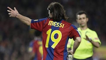 Before inheriting Barcelona's iconic No. 10 shirt, both Lionel Messi and Lamine Yamal wore the club's No. 19, a remarkable parallel in two extraordinary careers/Photo credit: Getty image - THEWILL NEWS MEDIA Soccer player wearing a red-and-blue jersey with the number 19, arms outstretched during a match.