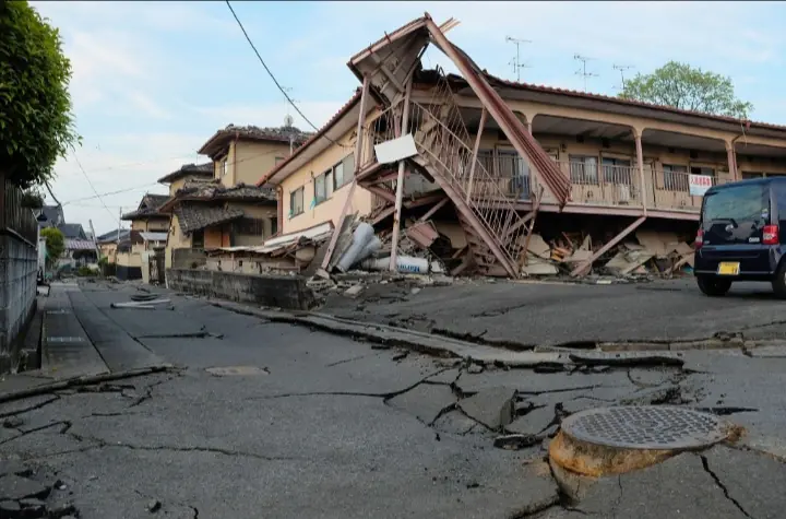 A damaged residential building and cracked roadway are seen in Kumamoto Prefecture after a powerful earthquake struck Japan's Kyushu region, causing widespread structural damage and prompting emergency response operations. Photo credit: Getty Images. - THEWILL NEWS MEDIA
