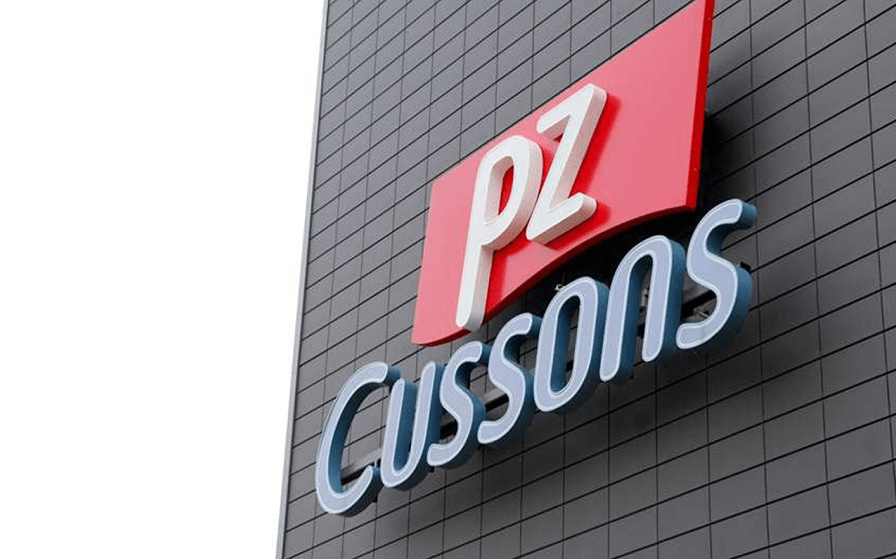 PZ Cussons logo on a dark tiled exterior wall of a building