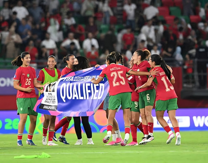 Morocco women's national team - THEWILL NEWS MEDIA Women’s soccer team in red and green jerseys celebrates on the field, holding a blue ‘QUALIFIED’ banner.