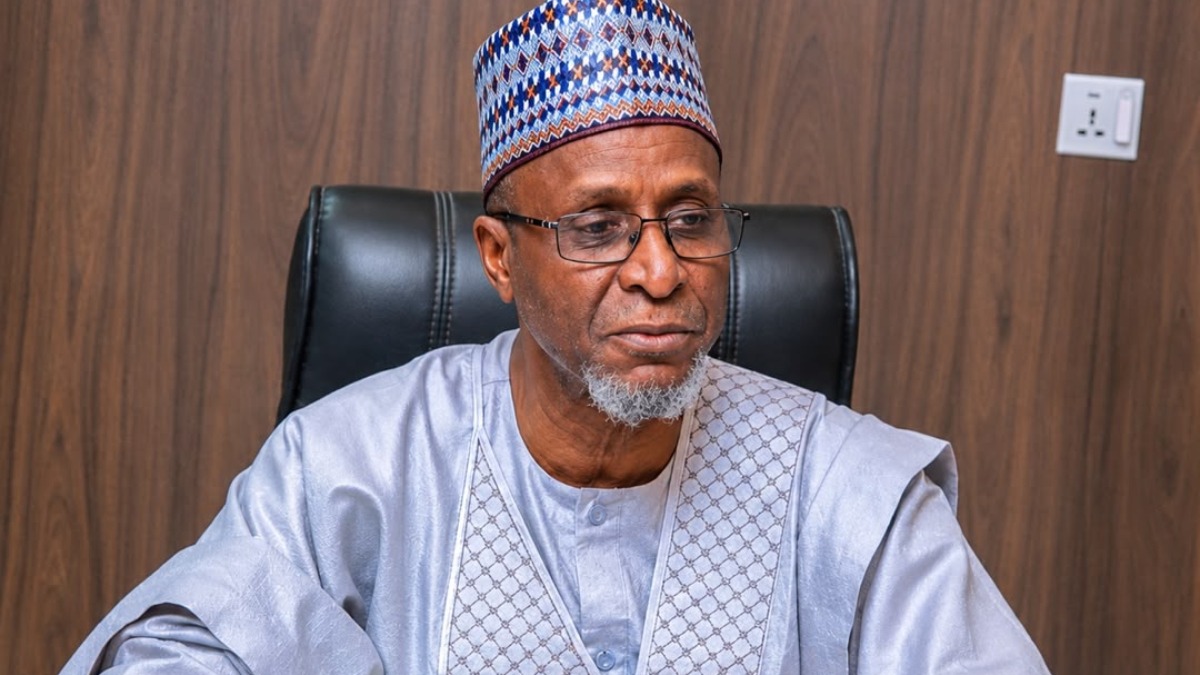 Balarabe Lawal - THEWILL NEWS MEDIA Portrait of an older man wearing a patterned cap and light gray traditional robes, seated in a black leather office chair against a wood-paneled wall, looking to his left.