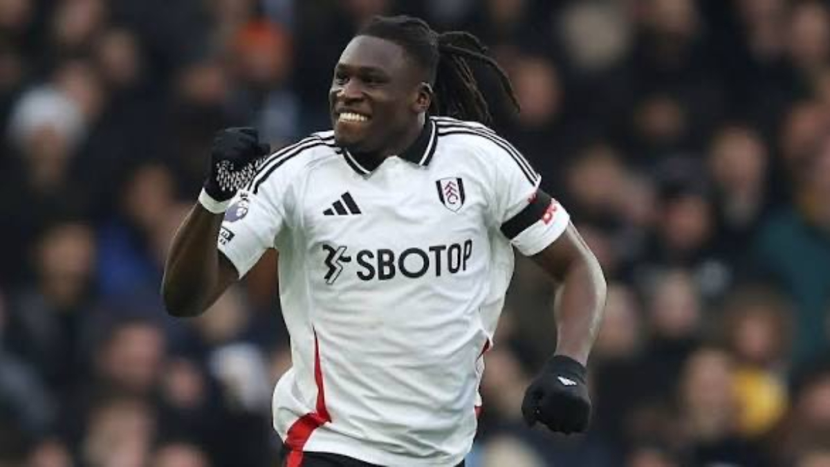 CALVIN BASSEY - THEWILL NEWS MEDIA Footballer in a white Fulham jersey celebrating a goal on the pitch, fist clenched.