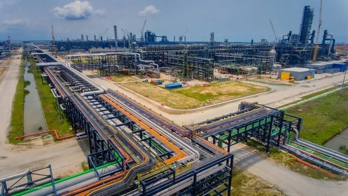 Dangote Petroleum Refinery - THEWILL NEWS MEDIA Overhead view of a large oil refinery with a dense network of colorful pipelines and tall processing towers.