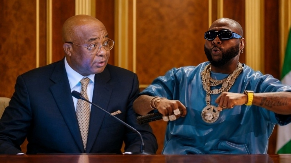 Davido and Uzodinma 1 - THEWILL NEWS MEDIA Formal scene: a government official in a suit speaks at a desk beside a rapper in blue with oversized gold chains and sunglasses.