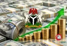 Nigeria’s Foreign Reserves Rise $7.1bn In Eight Months To $52.66bn Nigeria's coat of arms over stacks of cash and rising coins with a green growth arrow, symbolizing strong economic growth in Nigeria.