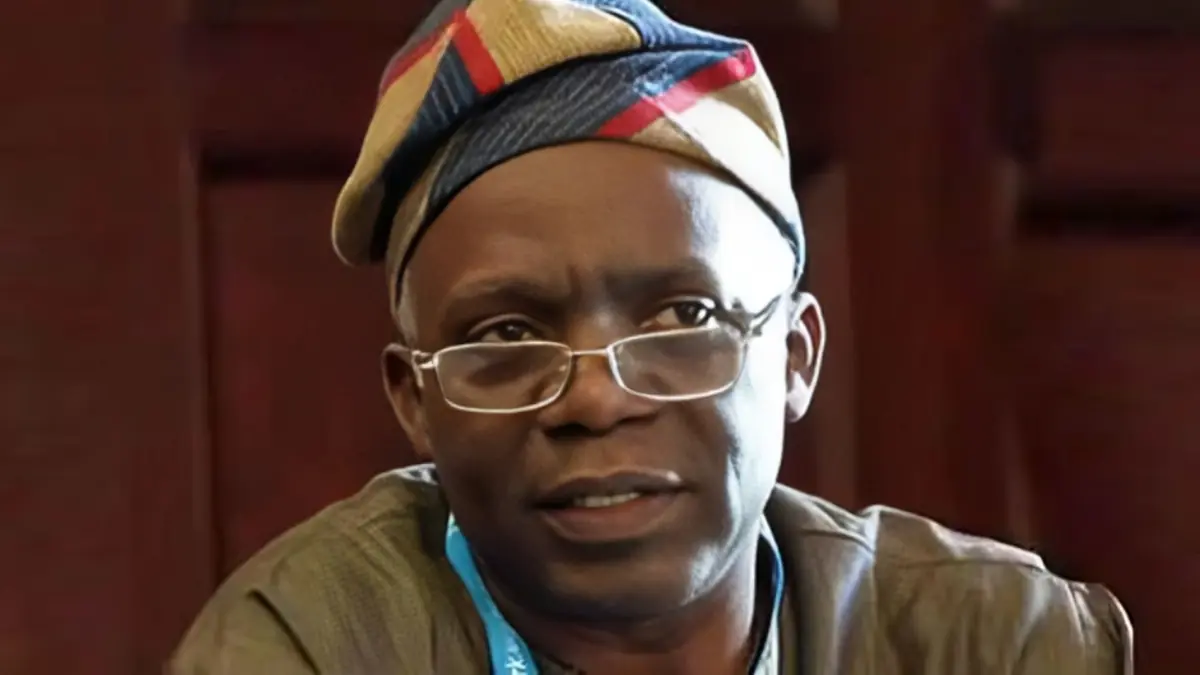 Femi Falana - THEWILL NEWS MEDIA Portrait of a man with a colorful head wrap and glasses, indoors, looking slightly to the side.