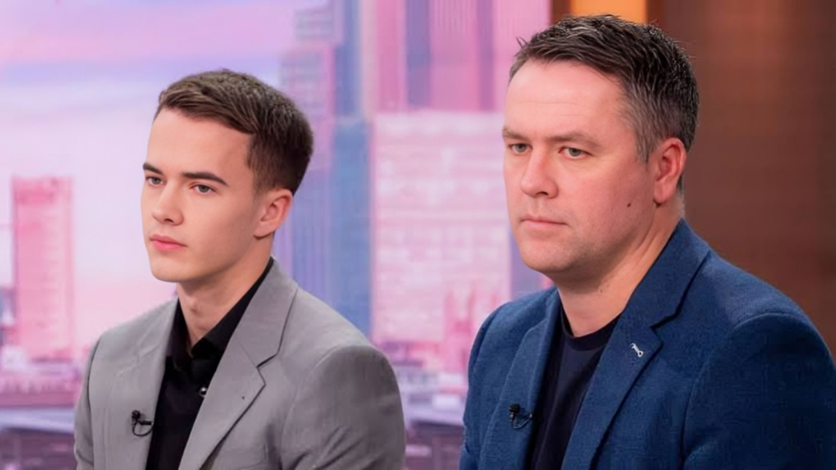 Michael Owen with his son Jamesson - THEWILL NEWS MEDIA Two men in blazers sit side by side in a TV studio during an interview or discussion.