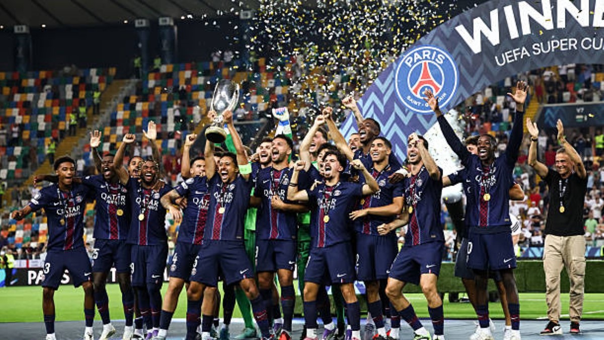 Paris Saint-Germain players celebrate with the trophy - THEWILL NEWS MEDIA Paris Saint-Germain players celebrate with the trophy after winning the UEFA Super Cup, confetti flying in the stadium stands.