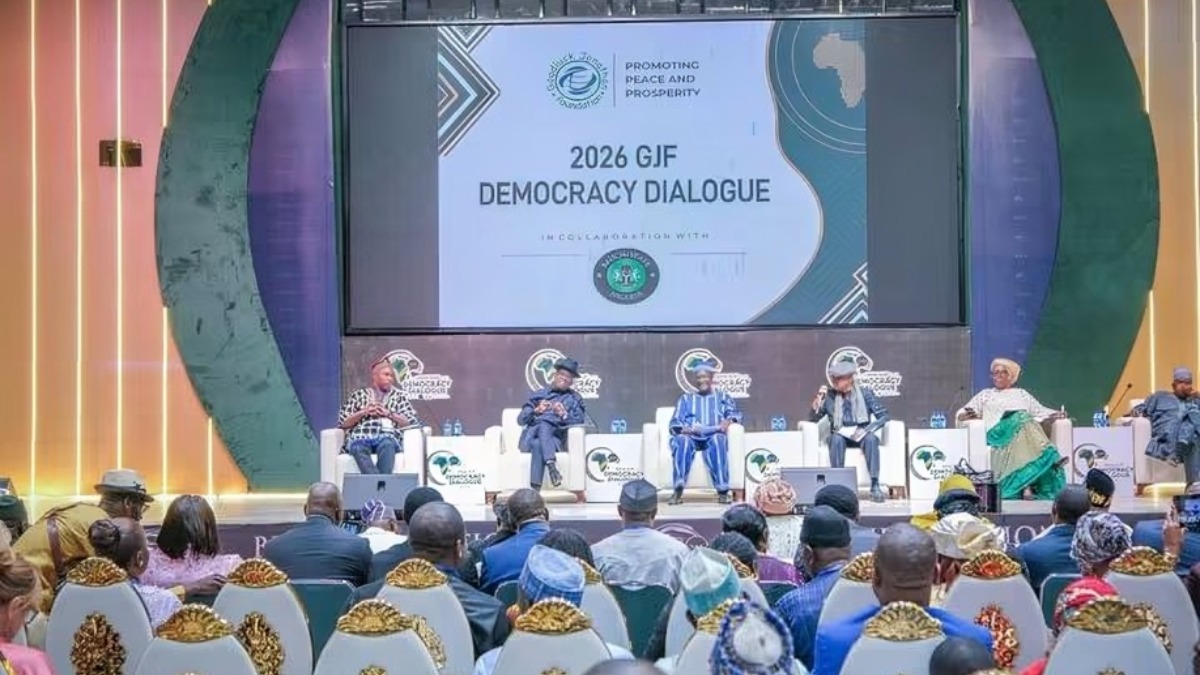 Participants engaged in a panel session at the 2026 Goodluck Ebele Jonathan Foundation Annual Democracy Dialogue - THEWILL NEWS MEDIA Panel discussion on stage at the 2026 GJF Democracy Dialogue, with five speakers seated in white chairs facing an audience.