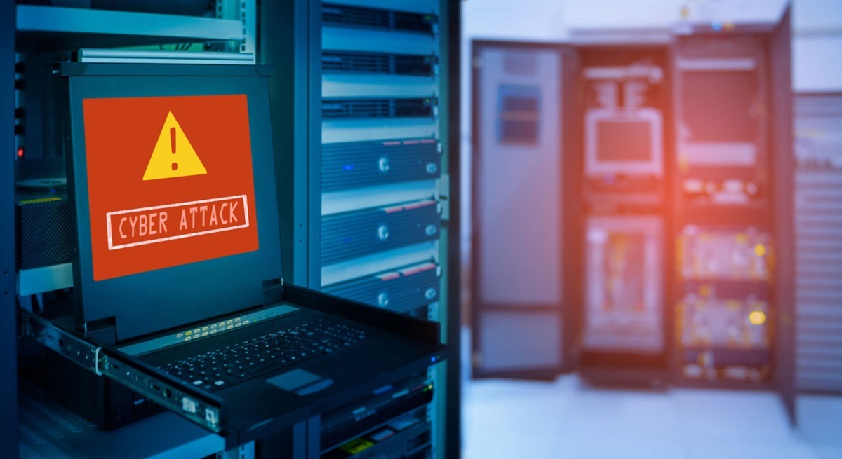 cyber attack - THEWILL NEWS MEDIA Laptop in a data center displays a red warning sign reading'CYBER ATTACK' in front of server racks in blue lighting.designed for an alert scenario