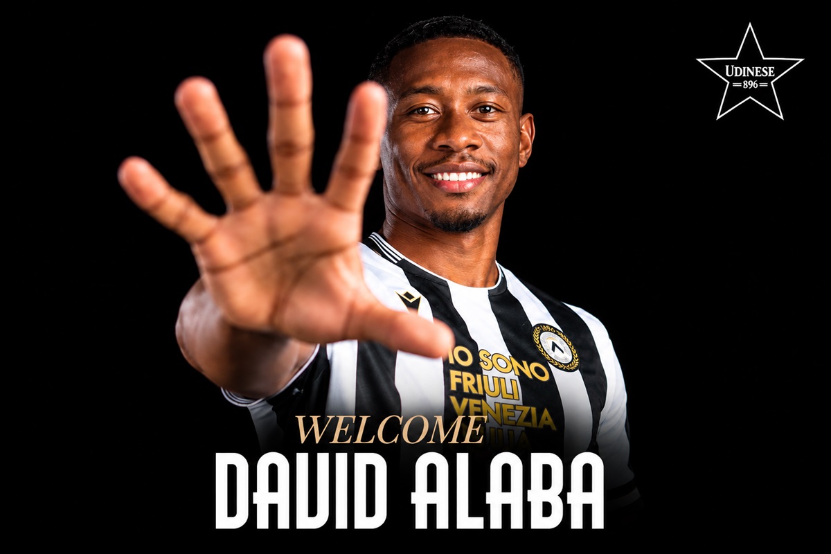 David Alaba - THEWILL NEWS MEDIA Professional portrait of a footballer in a black-and-white striped Udinese jersey, reaching out with his hand toward the camera as a welcome message reads 'Welcome David Alaba' in bold text on a black background.