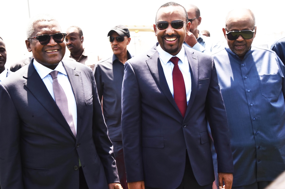 Ethiopia Djibouti leaders back Dangote - THEWILL NEWS MEDIA Group of men in dark suits and sunglasses smiling at the camera, with a man in a navy suit and red tie at center-driven selfie vibe outdoors.