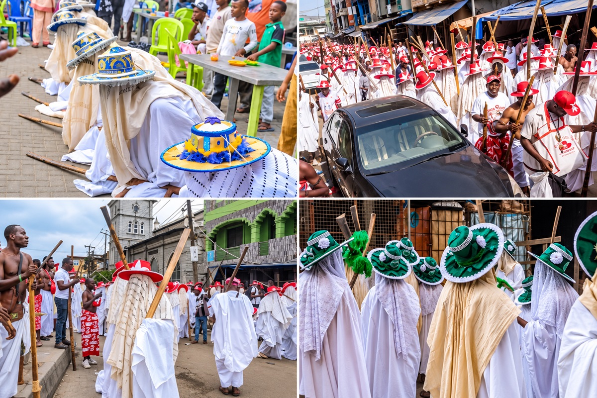 Eyo Festival - THEWILL NEWS MEDIA Procession of people in white robes with blue-yellow hats kneeling along a street as onlookers watch from colorful chairs behind them.