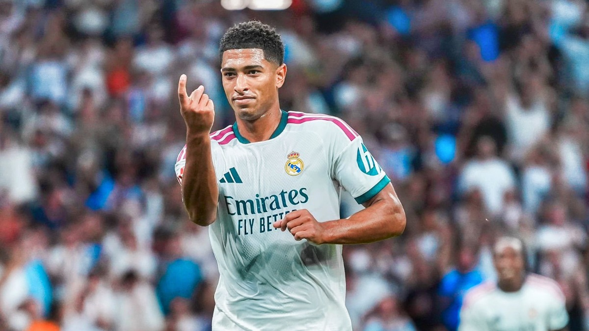Jude Bellingham - THEWILL NEWS MEDIA Real Madrid footballer celebrating on the field, right hand raised with a middle finger extended in celebration.