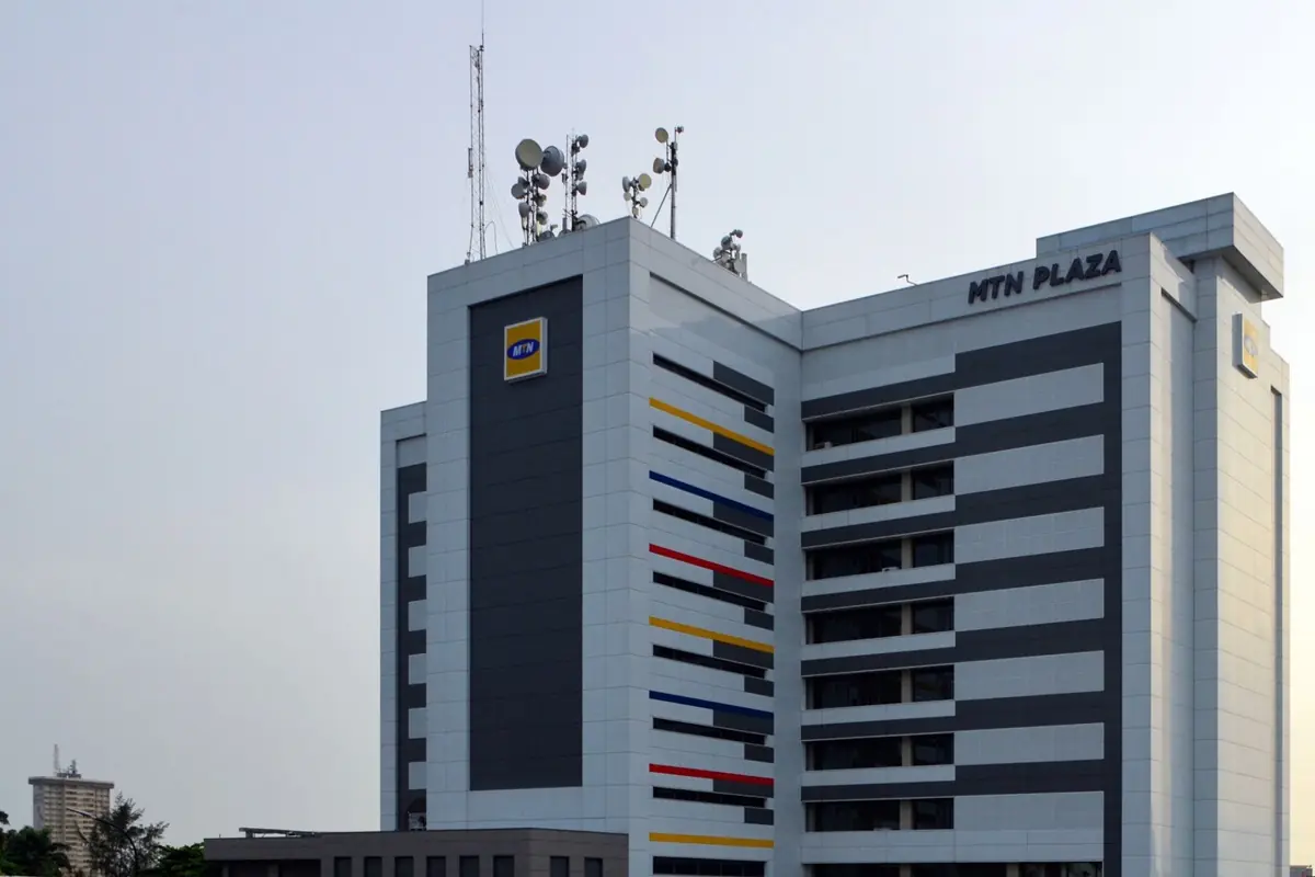 MTN - THEWILL NEWS MEDIA MTN Plaza high-rise with multicolored horizontal stripes and antennas on the roof