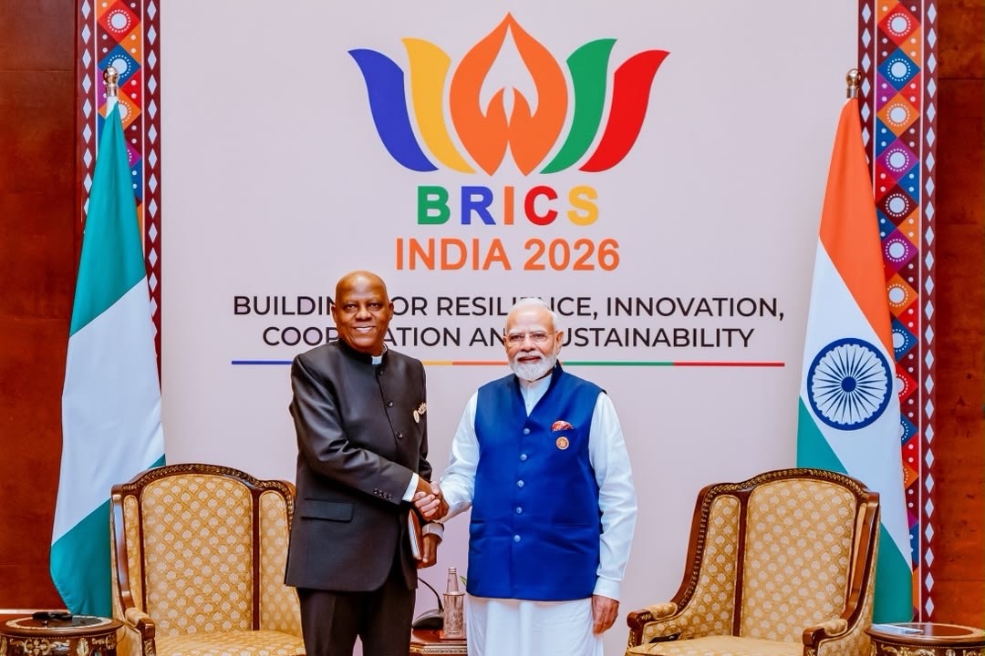 Vice President Kashim Shettima and India Prime Minister Narendra Modi - THEWILL NEWS MEDIA Two officials shake hands in front of a BRICS India 2026 backdrop, with flags of Nigeria and India visible to the sides.