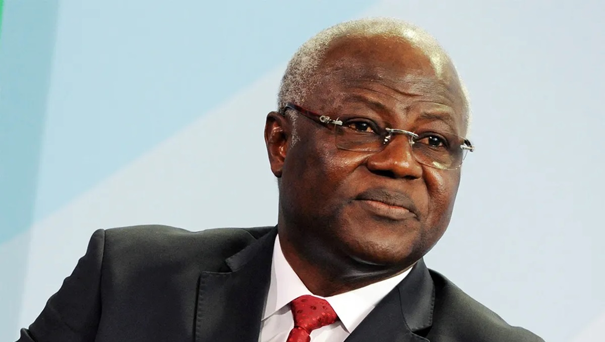 former Sierra Leone President Ernest Koroma - THEWILL NEWS MEDIA Portrait of a man in a dark suit, white shirt, and red tie, wearing glasses and looking to the side.