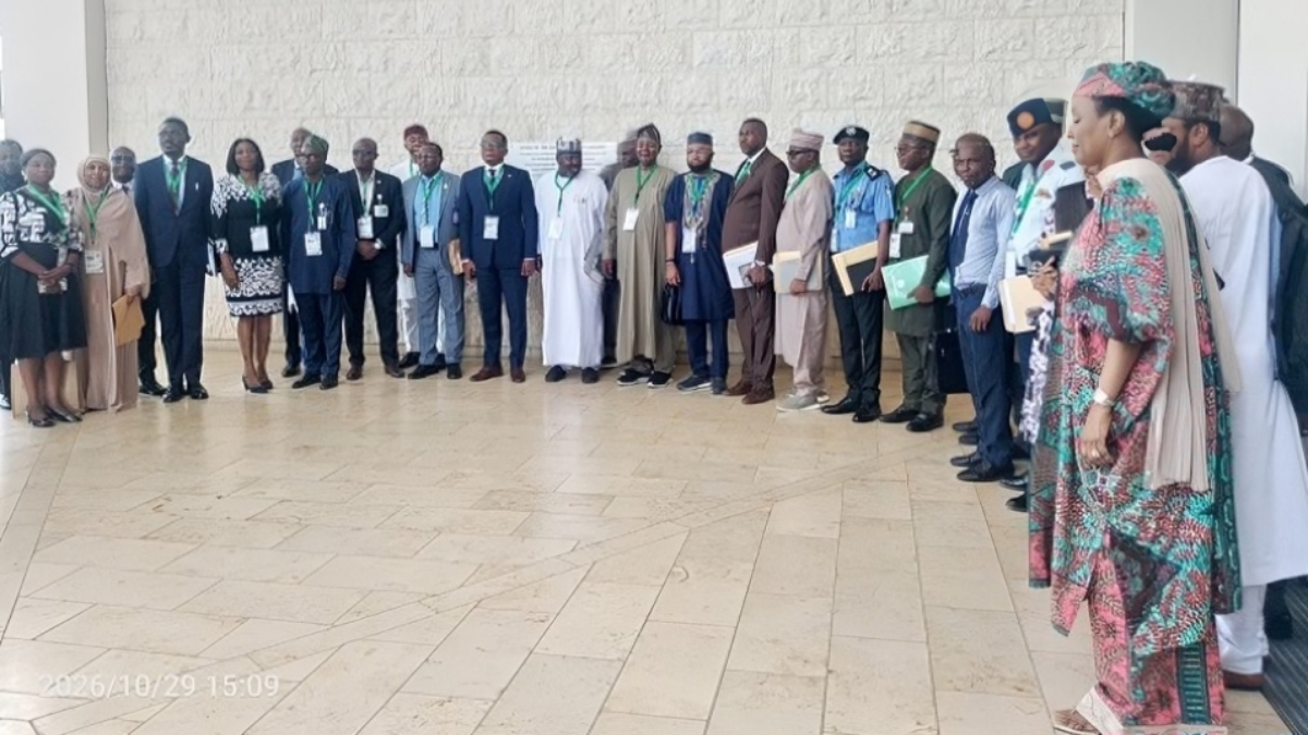 33-member committee for tackling emerging security threats - THEWILL NEWS MEDIA Group of officials and attendees in formal clothing standing in a line for a group photo at an event.