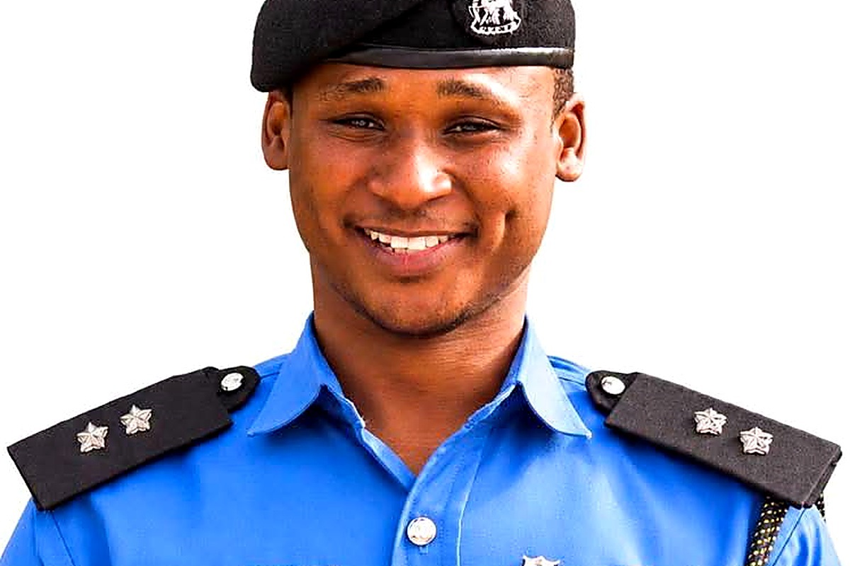 ASP Abdulaziz Maharazu - THEWILL NEWS MEDIA Male police officer in a blue uniform with shoulder insignia and a beret, smiling against a white background.