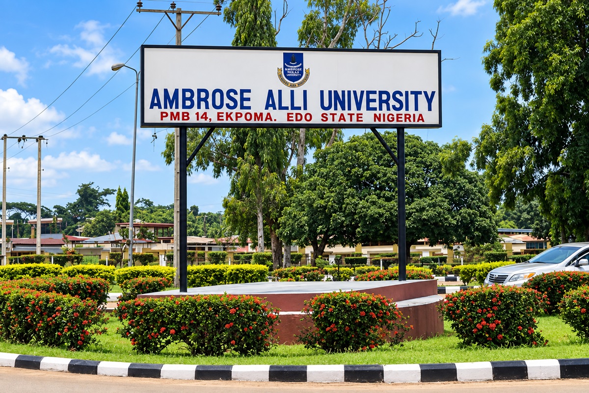 Ambrose Alli University AAU - THEWILL NEWS MEDIA Ambrose Alli University sign on a landscaped roundabout under a blue sky in Ekpoma, Nigeria