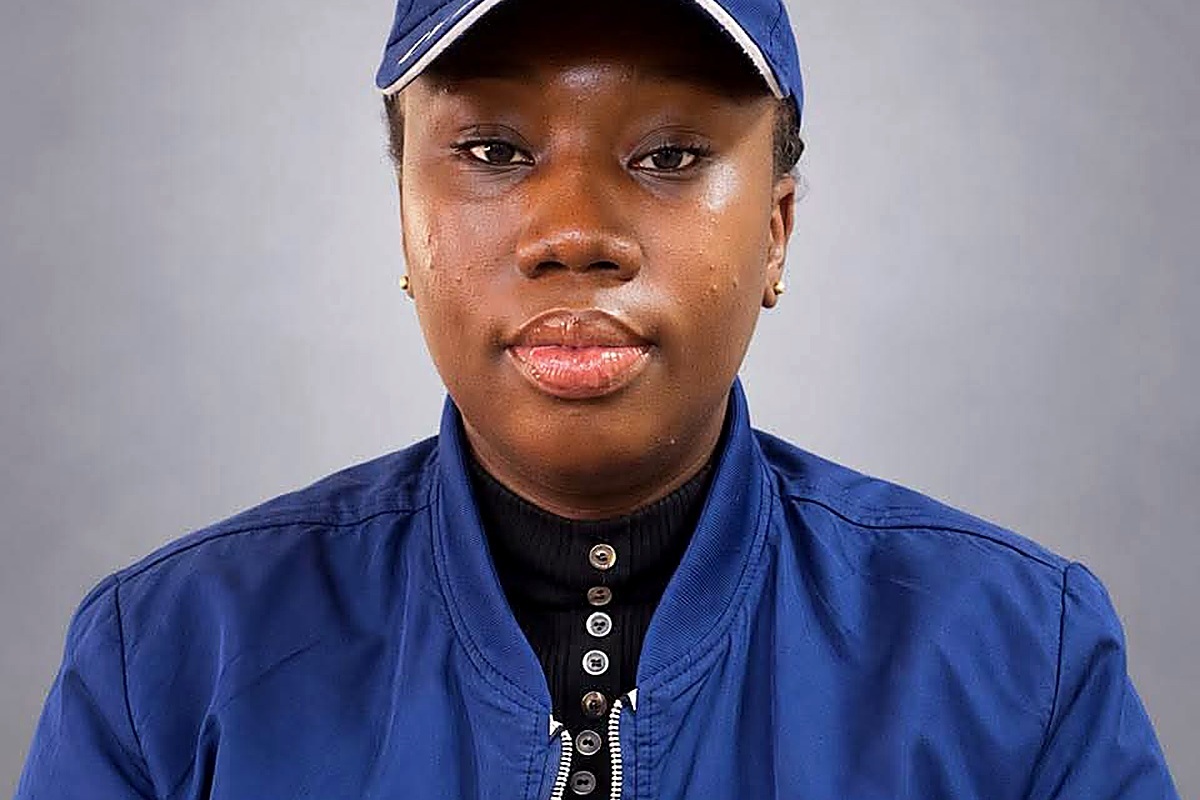 DSP Imah Unwana Victor - THEWILL NEWS MEDIA Portrait of a young woman wearing a blue cap and blue zip-up jacket over a black turtleneck, facing the camera.