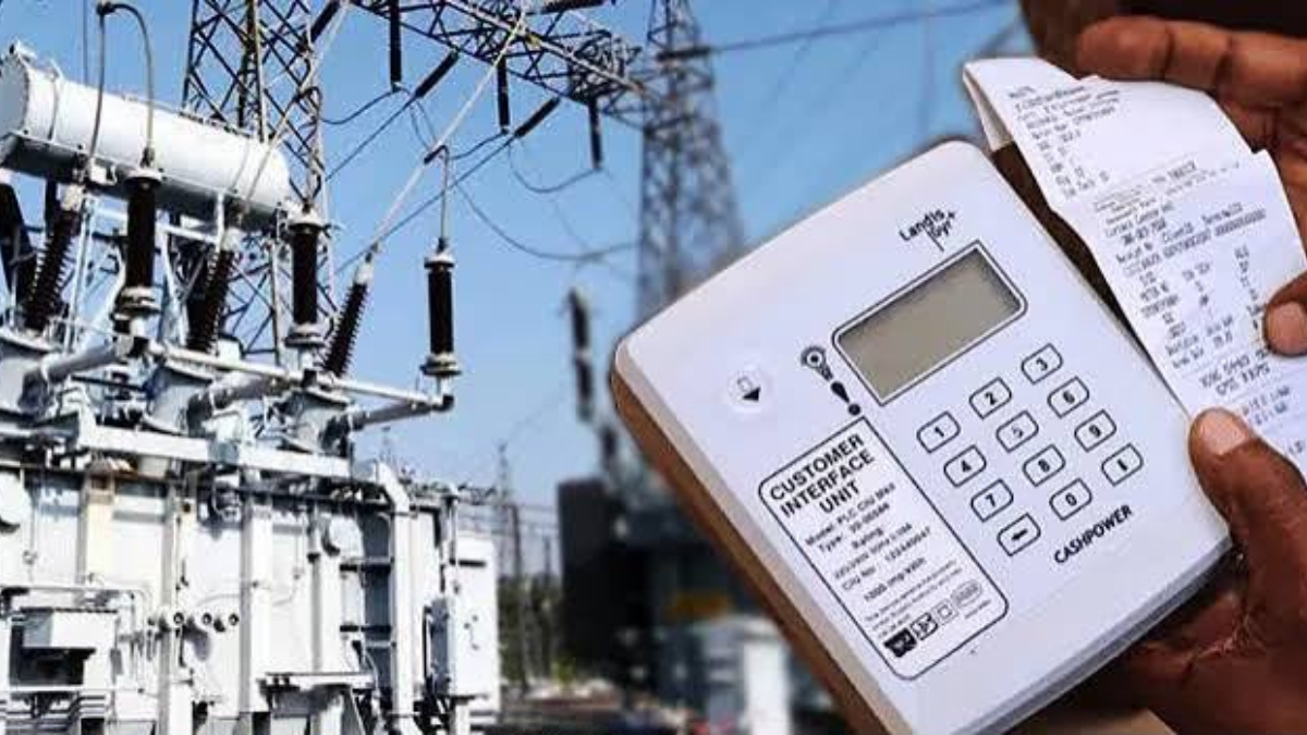 Electricity Bill - THEWILL NEWS MEDIA Hand holding a receipt printer/pay terminal beside an electrical substation and transformers, printing a receipt