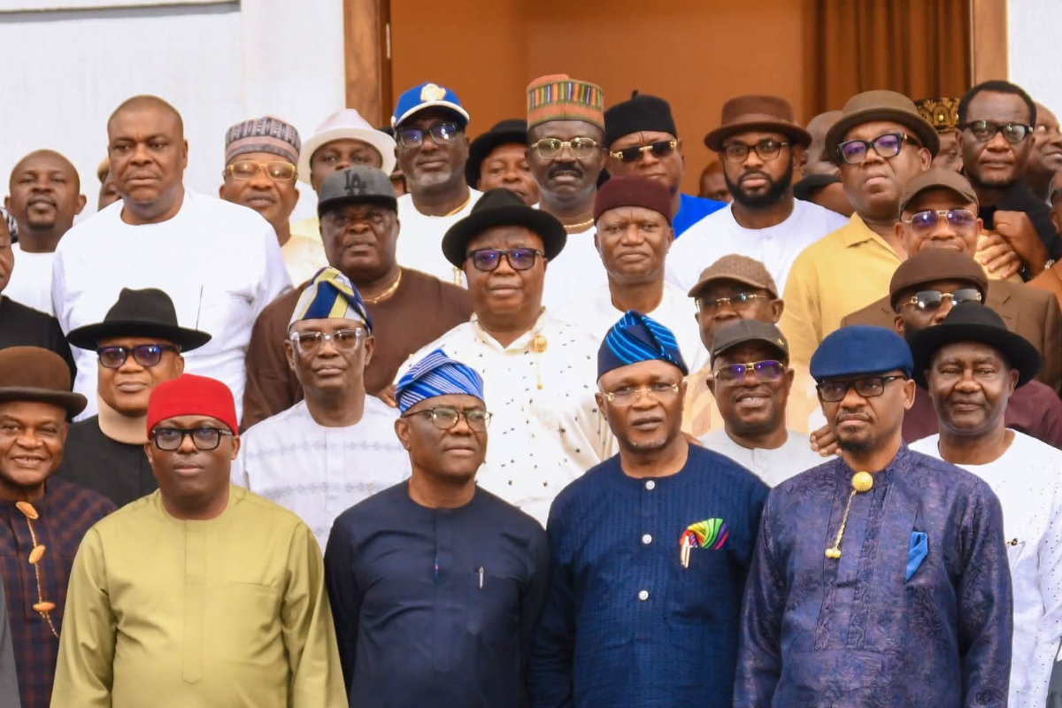 Fubara and Wike meets - THEWILL NEWS MEDIA Group of Nigerian men in traditional attire posing for a group photo on steps, wearing colorful hats, caps, and agbadas.