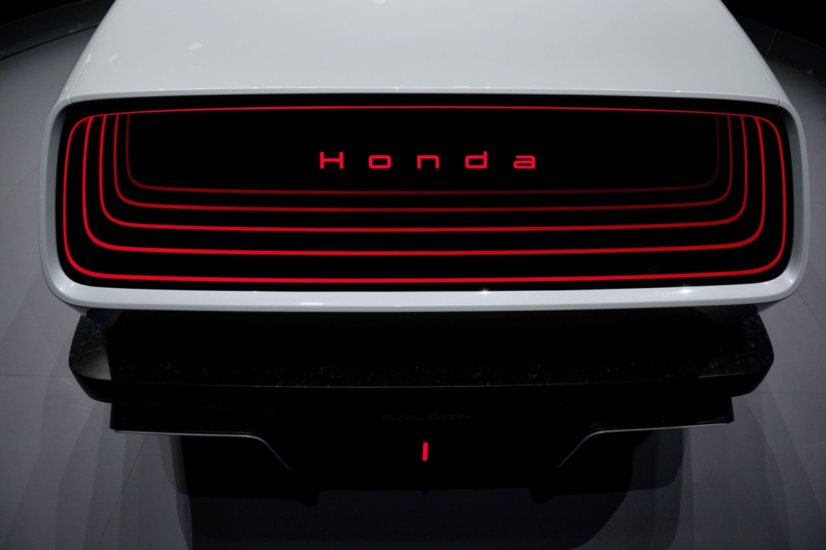 HONDA - THEWILL NEWS MEDIA Front view of a white Honda concept car with red illuminated grille rings and branding.