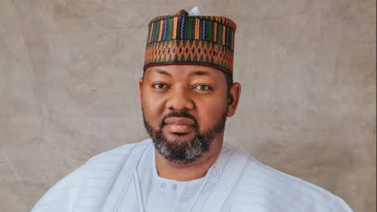 Ismaeel Ahmed - THEWILL NEWS MEDIA Man in a light blue traditional outfit and patterned cap posing for a formal portrait against a neutral backdrop.