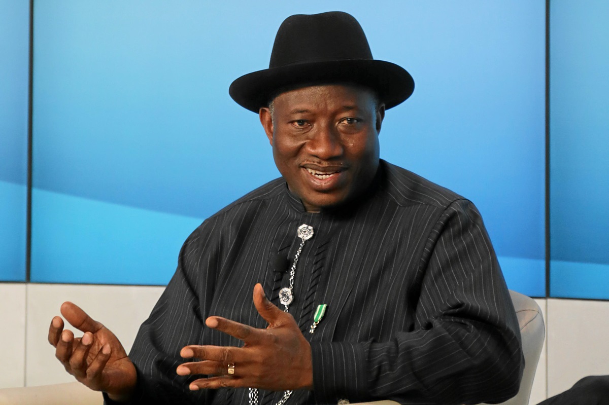 Jonathan - THEWILL NEWS MEDIA Man wearing a black hat and pinstripe outfit speaks, gesturing with hands during an interview or discussion.