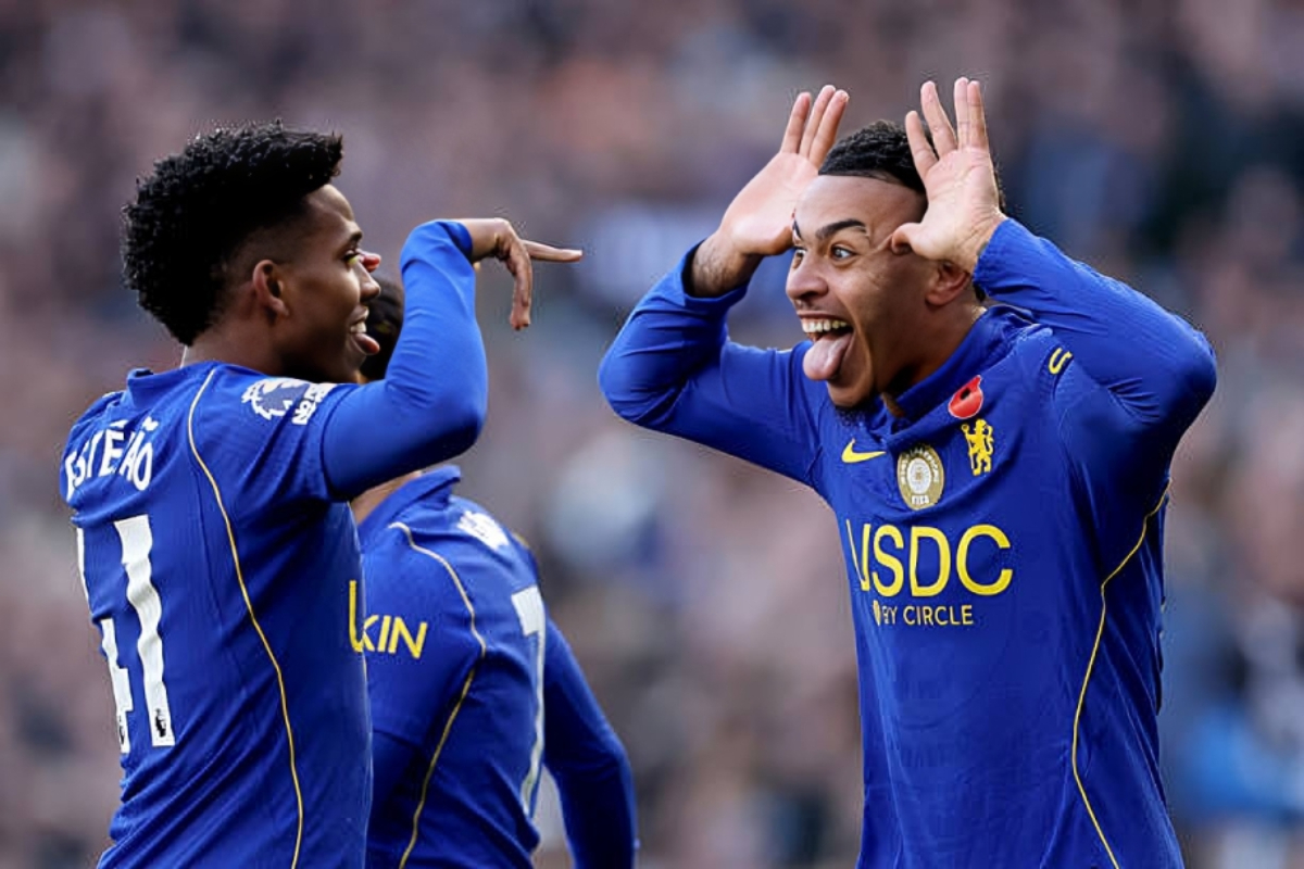 Morgan Rogers - THEWILL NEWS MEDIA Two Chelsea players in blue kits celebrate a goal on the pitch, one with hands near his head and tongue out in excitement.
