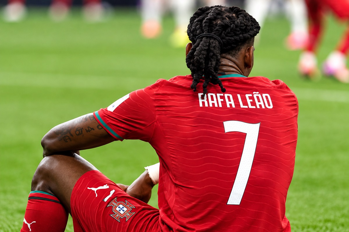 Rafael Leão - THEWILL NEWS MEDIA Portugal footballer Rafa Leão seen from behind, red jersey with name and number 7 on a green training field, during warm-up or practice.