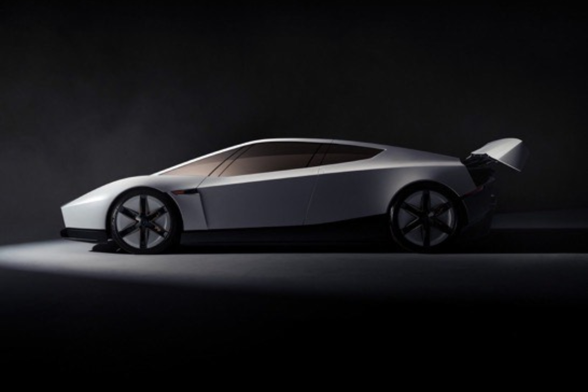 Teslas redesigned Roadster - THEWILL NEWS MEDIA White futuristic sports car with a large rear wing, showcased in a dark studio setting.