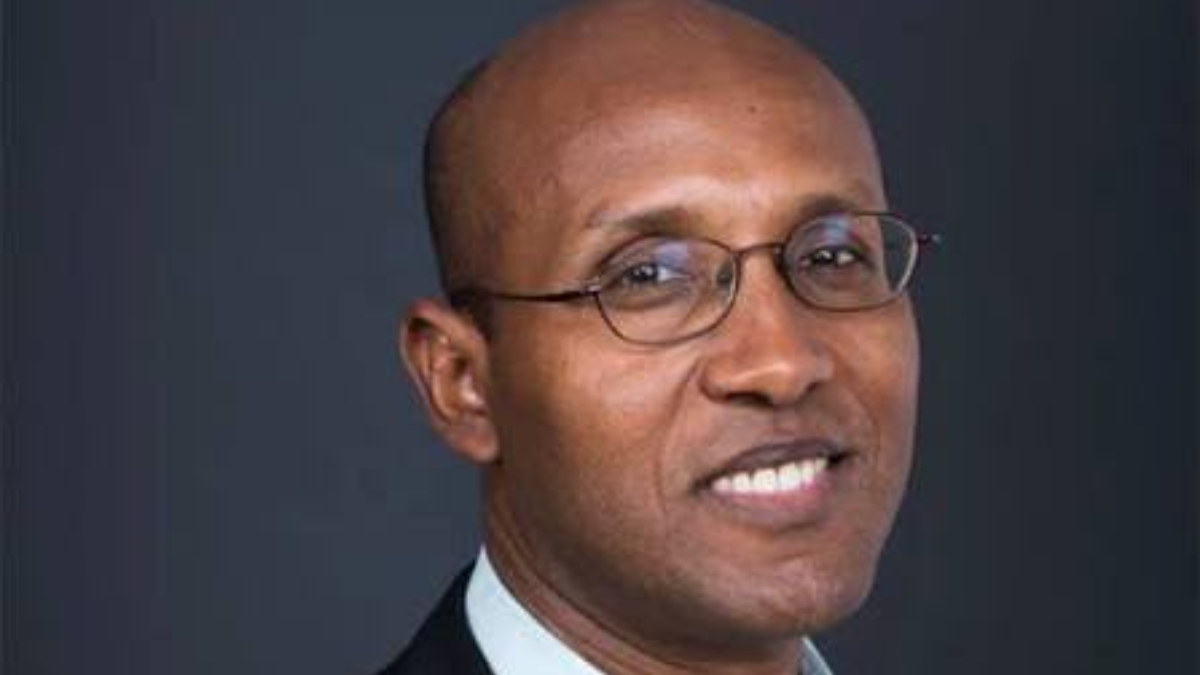 The World Banks Chief Economist for Africa Andrew Dabalen - THEWILL NEWS MEDIA Head-and-shoulders portrait of a smiling man wearing glasses against a dark background.